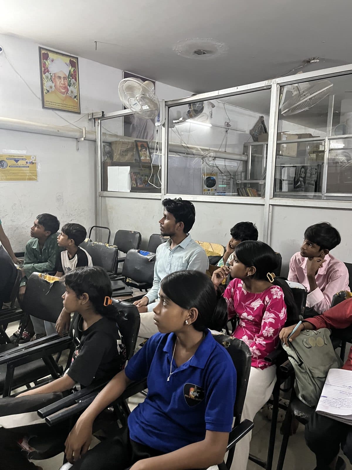 Students seated closely together at Prayatna during the Edugram session, seen from above.